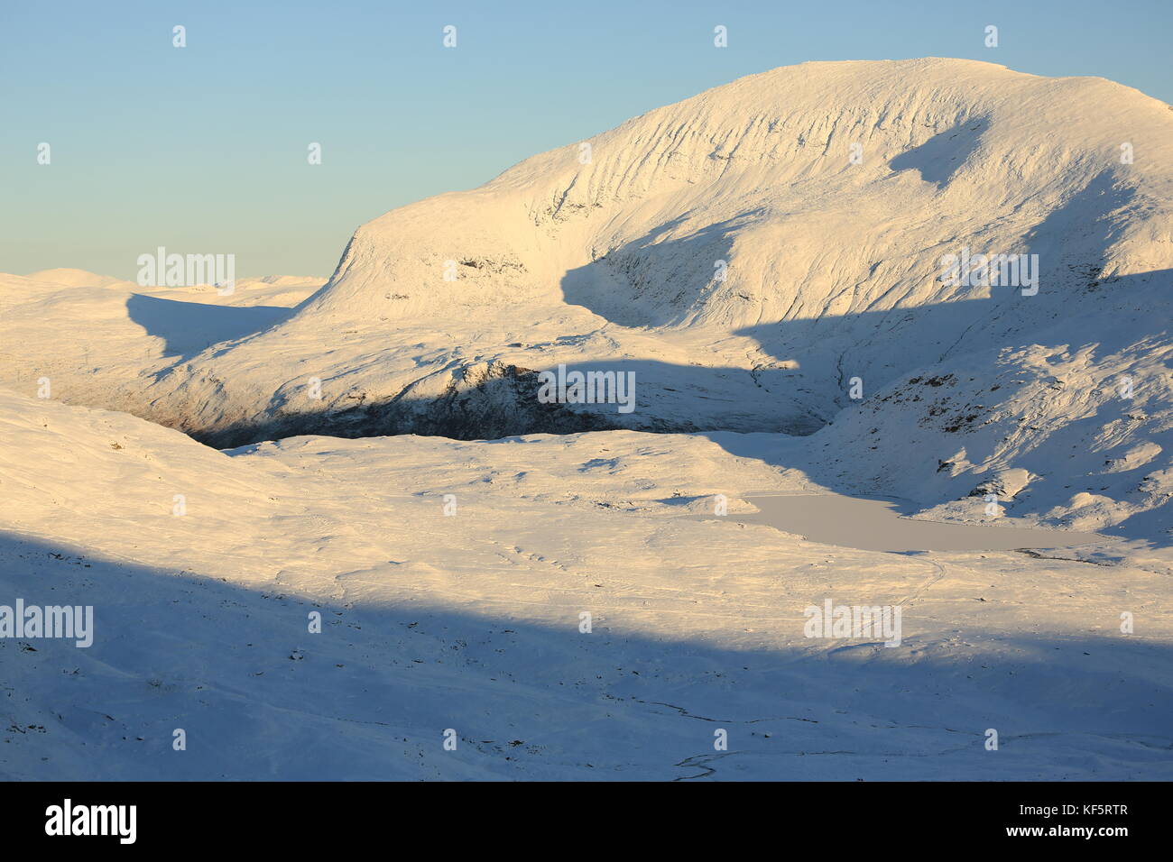 Tromsdalstind Covered In Snow In Autumn Sun Stock Photo