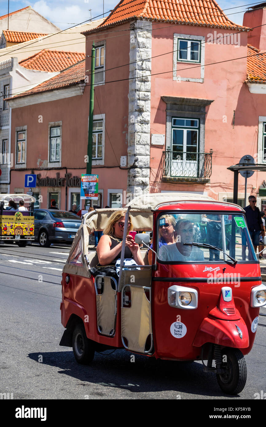 Lisbon Portugal,Belem,historic district,Rua de Belem,tuk-tuk,tricycle,cycle rickshaw,man men male,woman female women,driver,passenger passengers rider Stock Photo