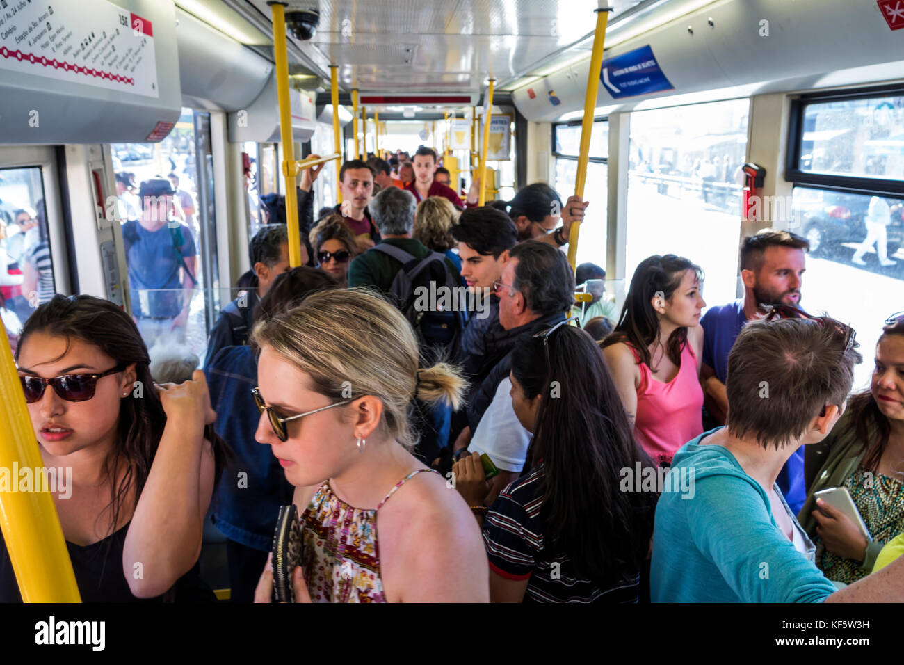 Lisbon Portugal,Carris,Tram 15,trolley,Belem Highway Route,crowded,passenger passengers rider riders,standing,Hispanic,immigrant immigrants,man men ma Stock Photo
