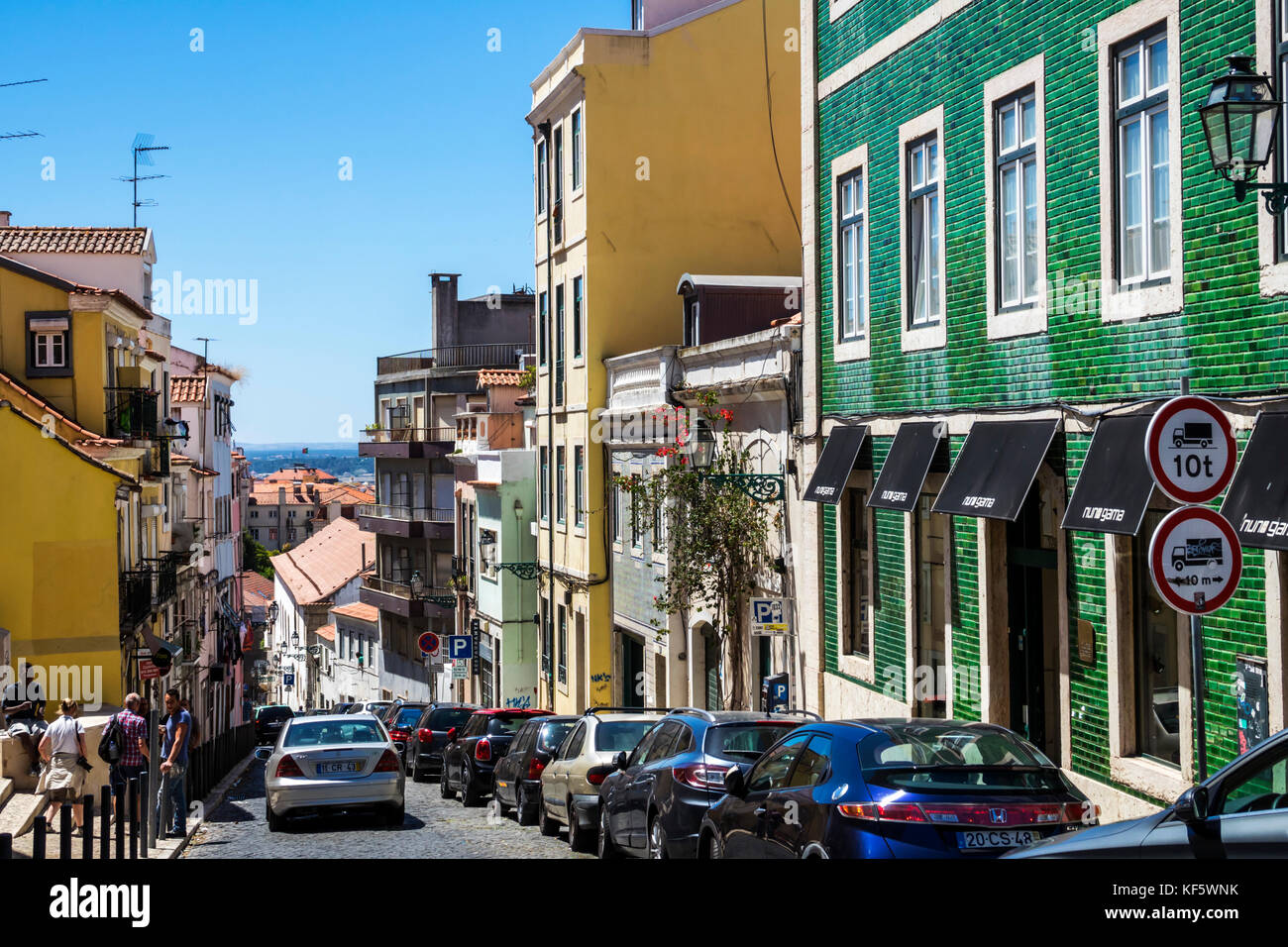 Lisbon Portugal,Bairro Alto,historic district,Principe Real,buildings,descending street,parked cars,residential apartment buildings,azulejos,painted t Stock Photo