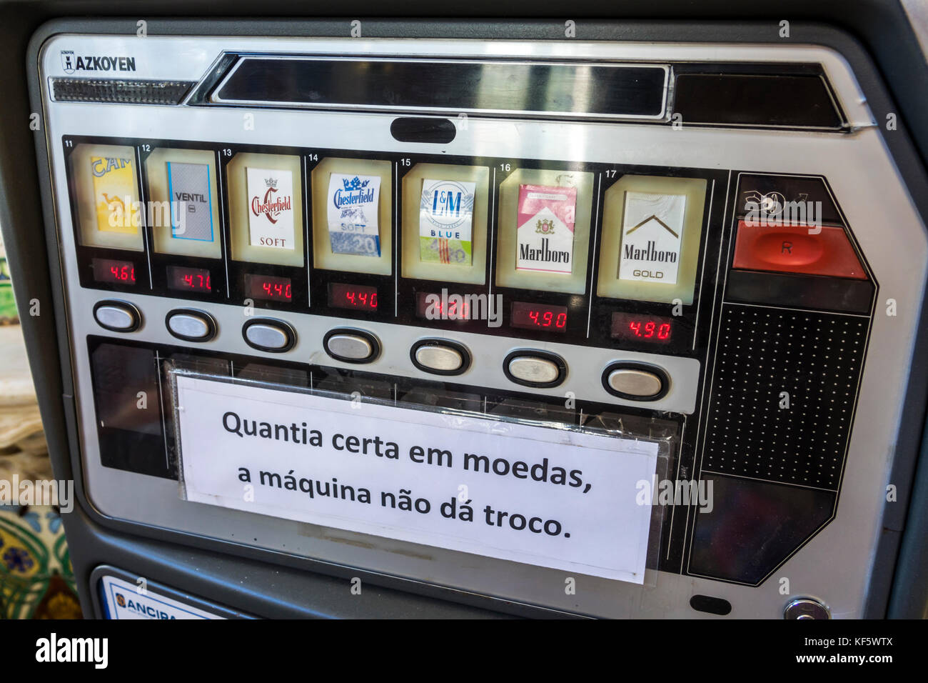 Lisbon Portugal,Bairro Alto,historic district,Catedral do Pao,cigarette vending machine,exact change,sign,Portuguese language,Marlboro,Chesterfield,Ca Stock Photo
