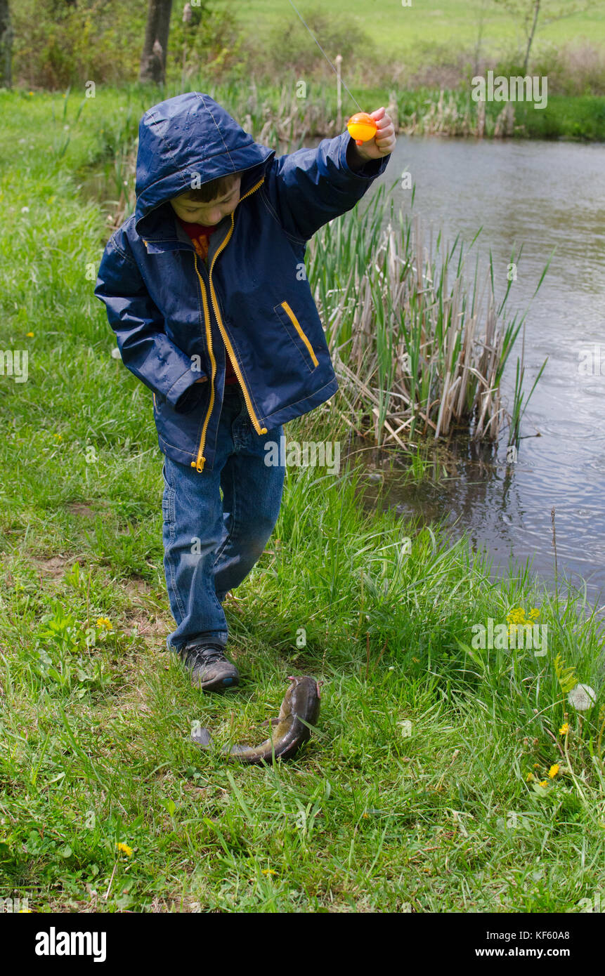 56 year old boy fishing by a pond in summer Stock Photo Alamy