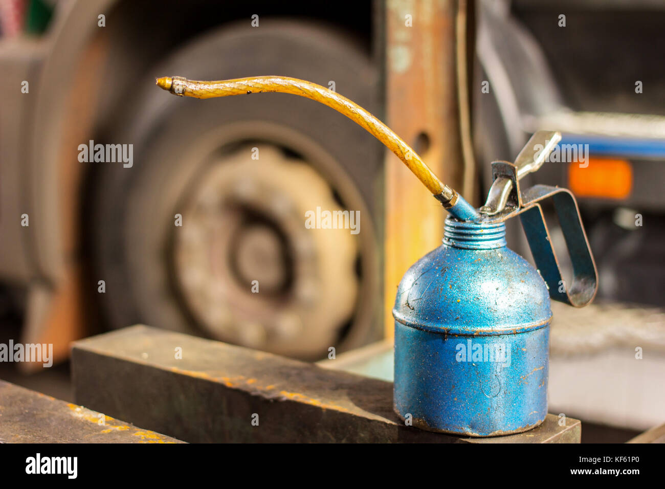 lubricant oil can and truck waiting for automobile mechanic checking in the garage Stock Photo
