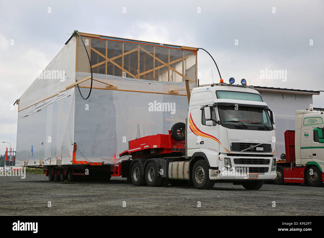 FORSSA, FINLAND - AUGUST 10, 2017: White Volvo FH semi trailer of Rahti-Kaleva Oy is to transport a prefabricated house module as oversize load in Sou Stock Photo