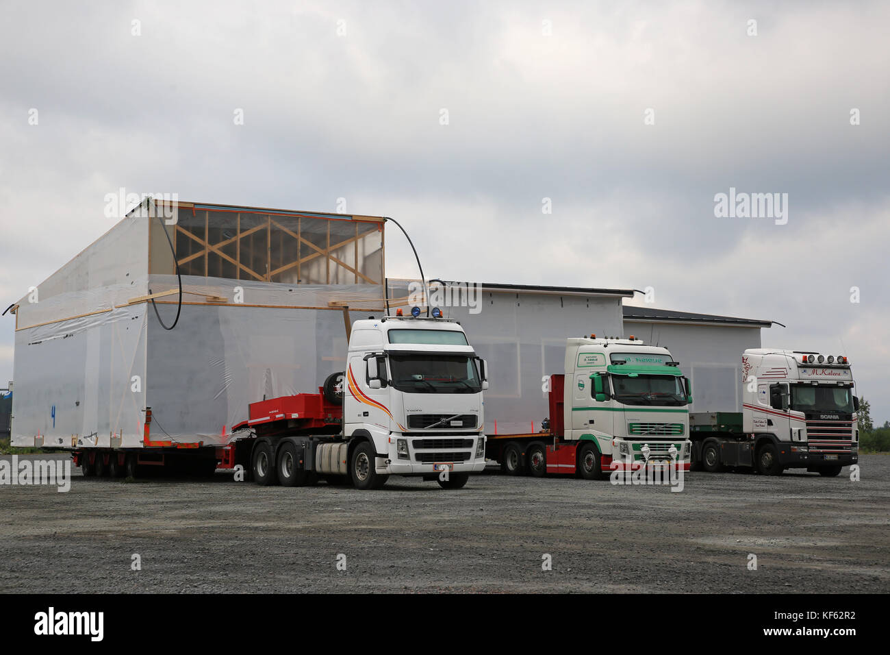 FORSSA, FINLAND - AUGUST 10, 2017: Three oversize load transports of prefabricated house modules, hauled by M. Kaleva semi trailer trucks, parked on a Stock Photo