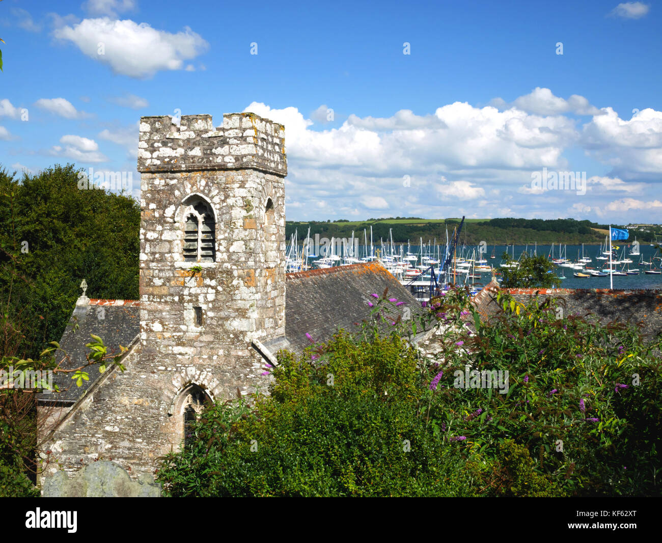The church of St Melorus at Mylor in Cornwall overlooks the creek of the River Fal. Stock Photo