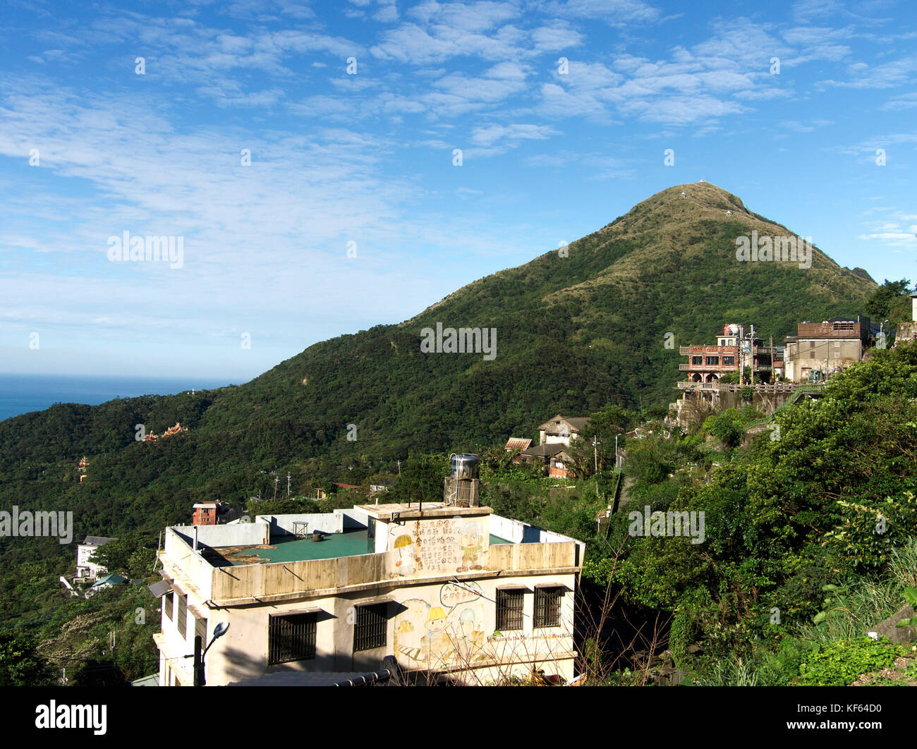 Keelung Mountain Hiking Trail with Residential Apartment blocks at the foot of the hill and view of the sea, Jiufen, Ruifang District, Taiwan Stock Photo
