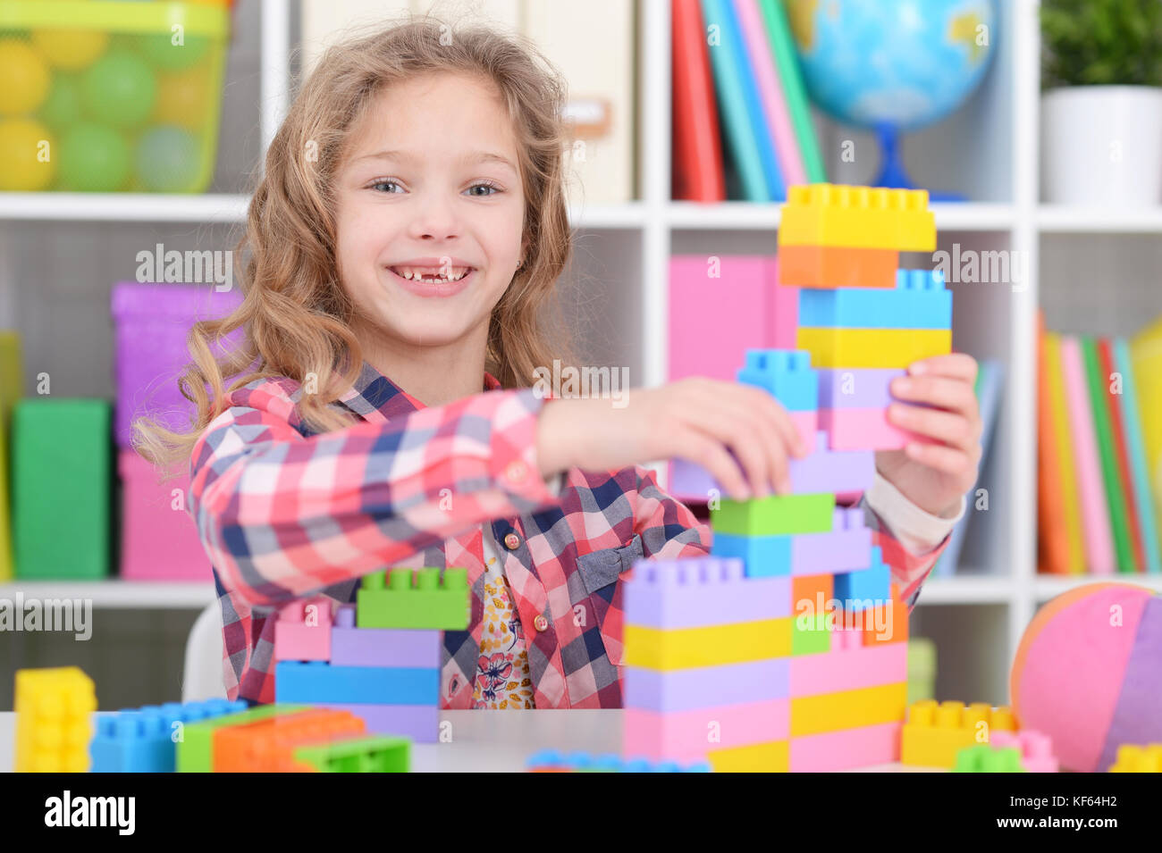 girl playing with plastic blocks Stock Photo - Alamy