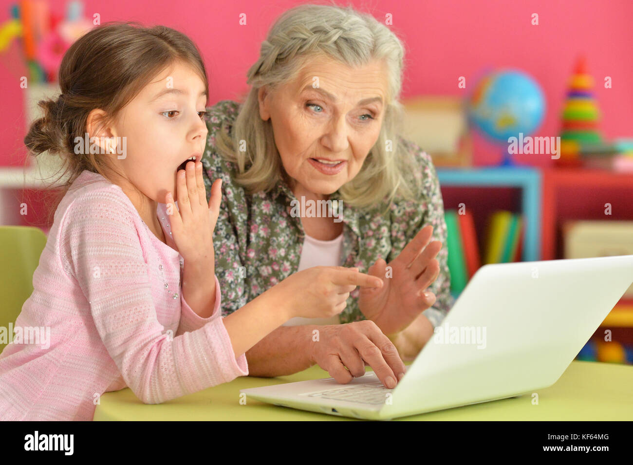 girl with grandmother using laptop Stock Photo - Alamy