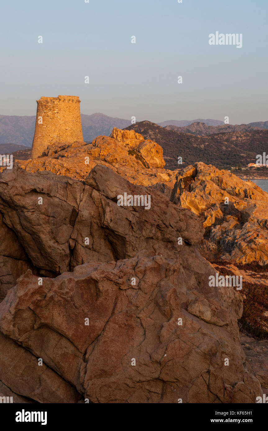 Corsica: sunset and skyline of Ile-Rousse (Red Island) seen from the top of the Ile de la Pietra (Stone Island) with view of the ruined Genoese Tower Stock Photo