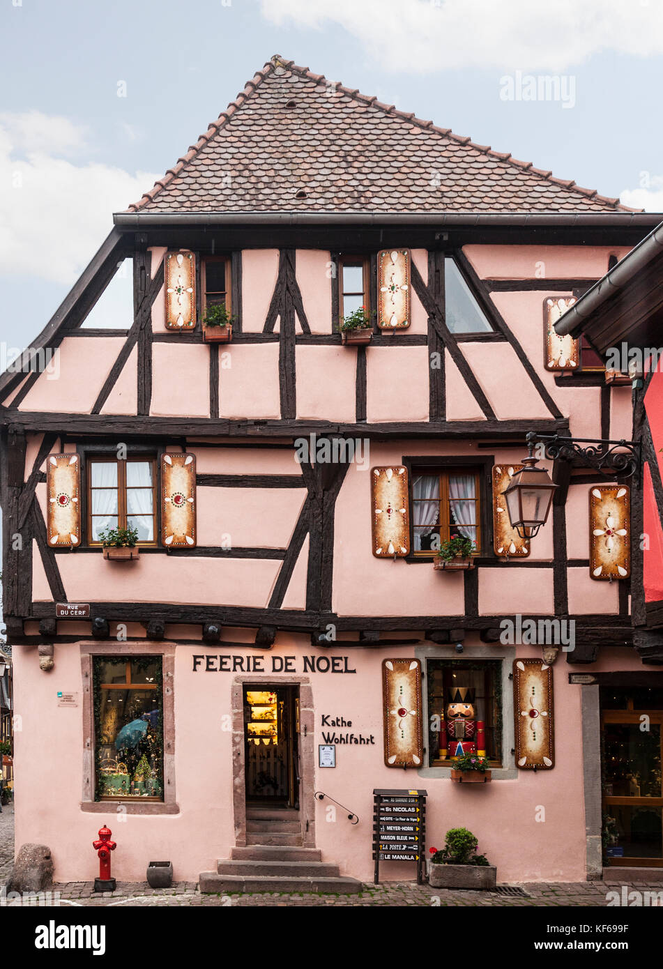 Feerie de Noel, a specialist Christmas shop in a painted, half-timbered medieval building in the village of Riquewihr in Alsace, France. Stock Photo