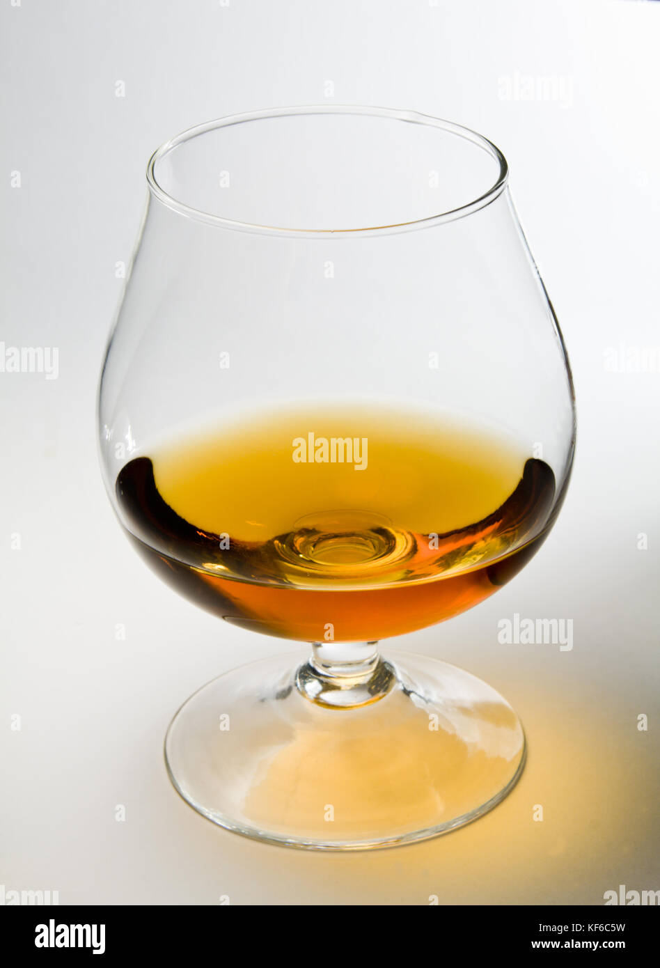 Snifter glass of cognac on white background Stock Photo Alamy