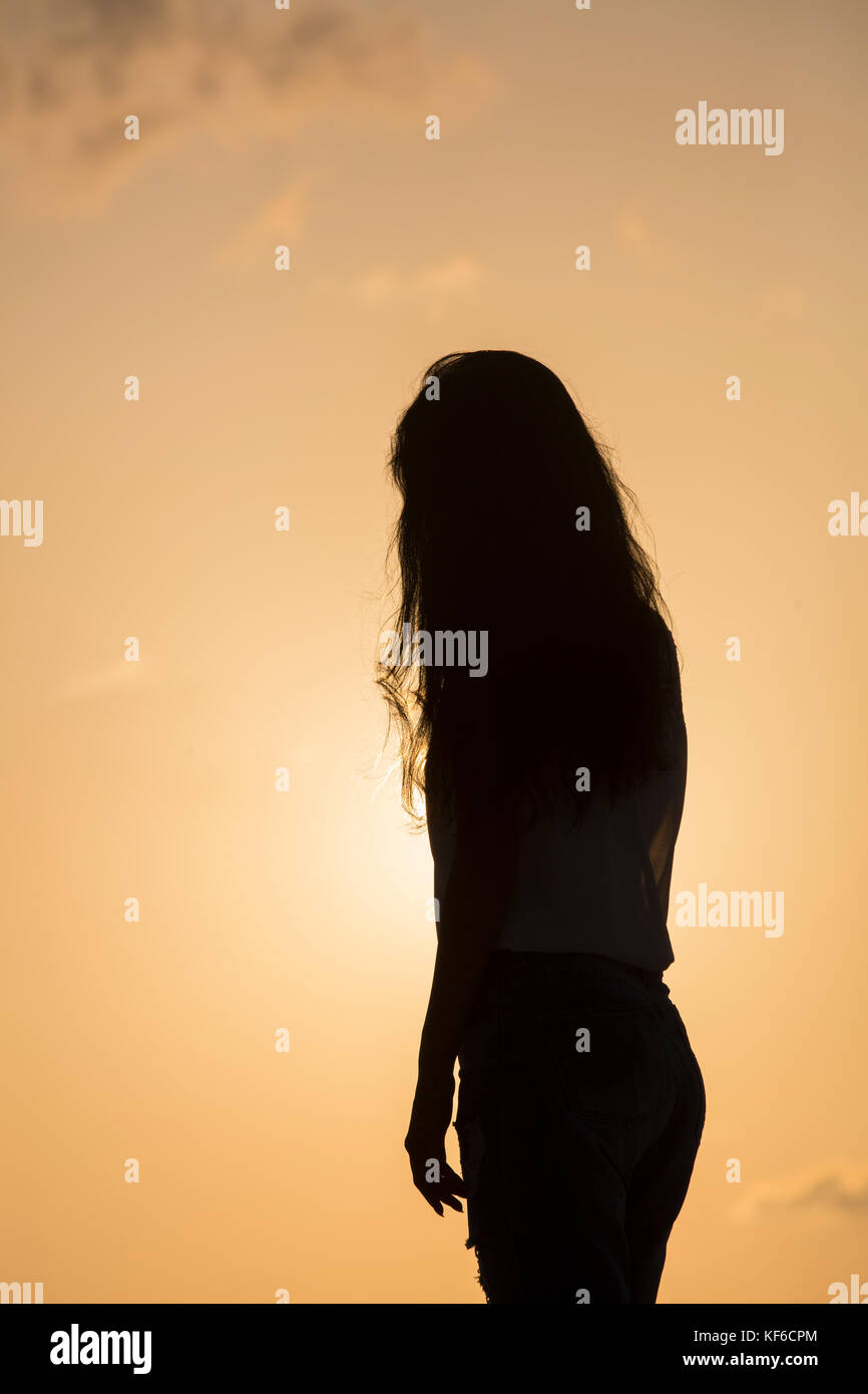 Photo of silhouette adult woman in profile on twilight background. Lonely  woman standing alone moments sunset. Style abstract shadows. Let's Stay  Toge Stock Photo - Alamy