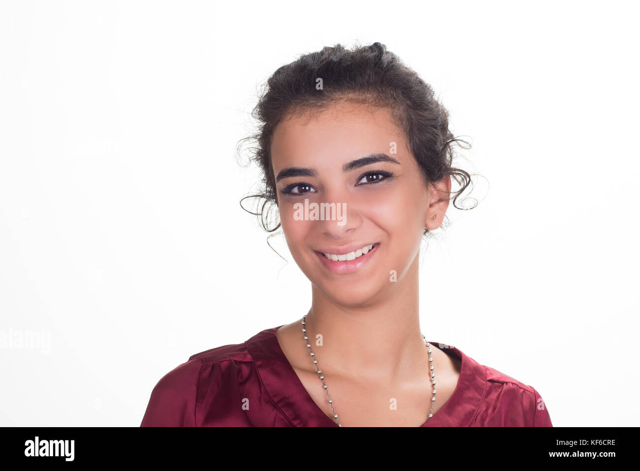 Happy young woman smiling against a white background Stock Photo - Alamy
