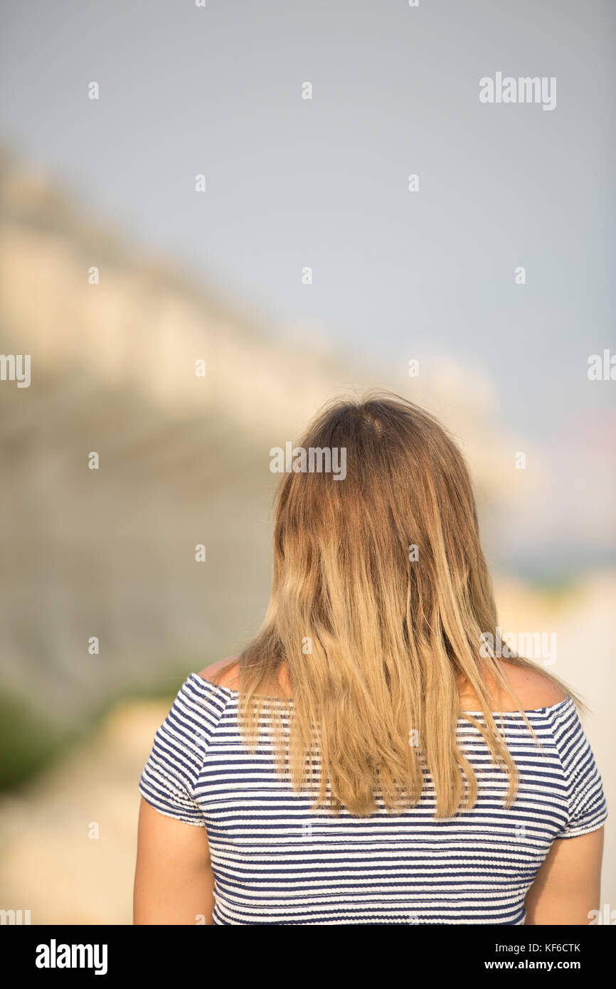 Rear view of a young woman walking outdoors Stock Photo - Alamy
