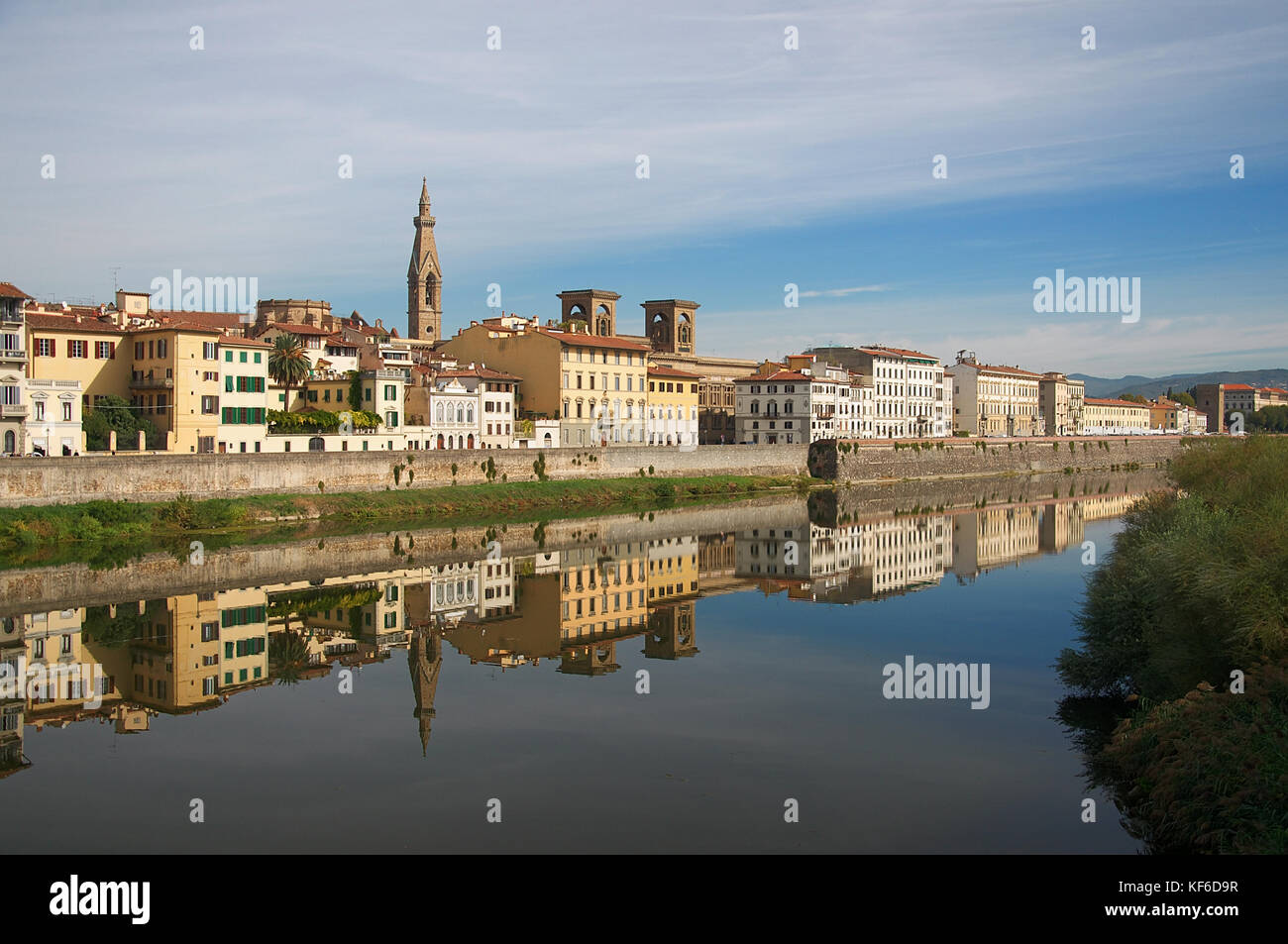 Part of the riverside of Florence reflected in the calm water of the Arno River Stock Photo