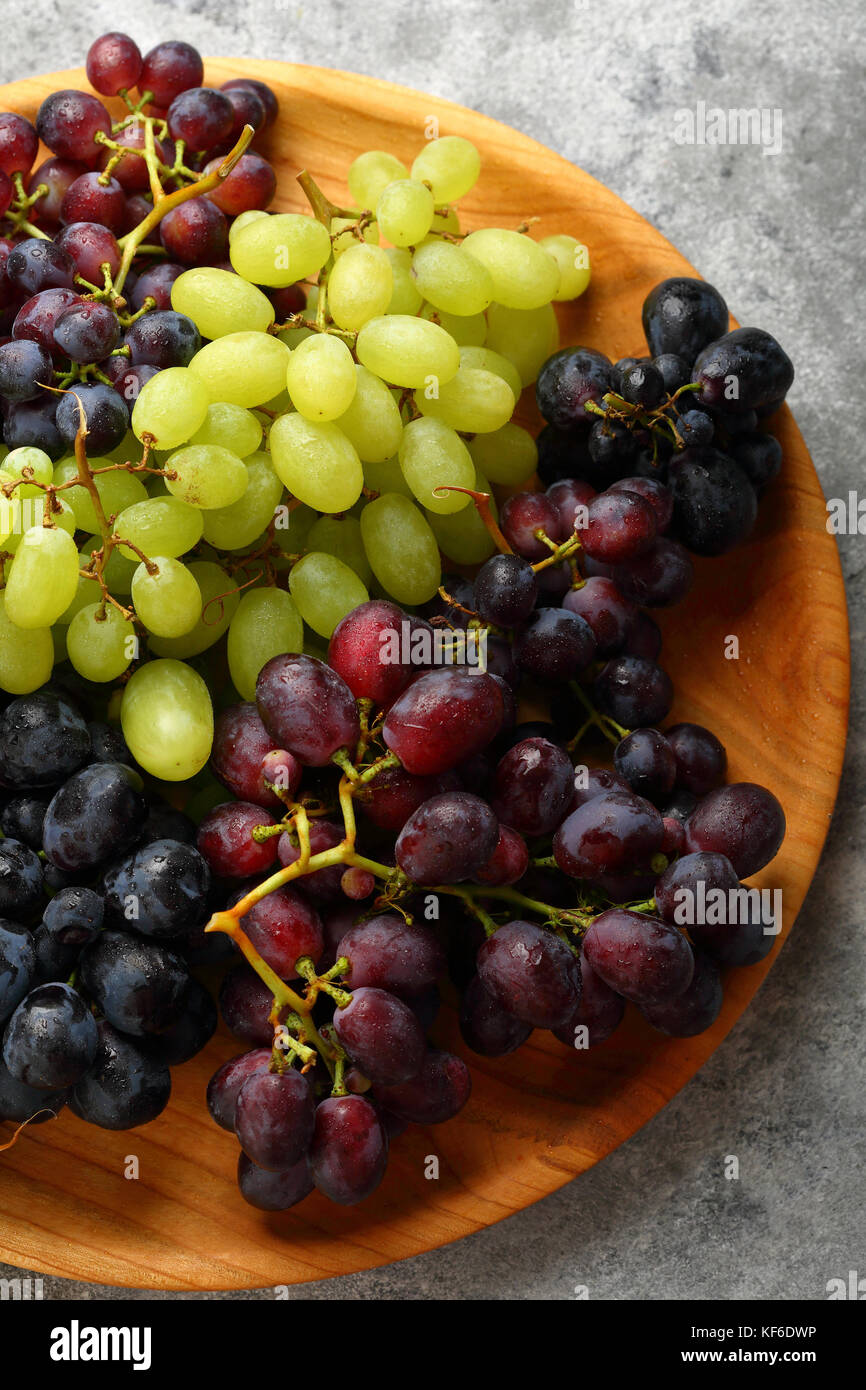 Fresh grapes mix on wood dish Stock Photo Alamy