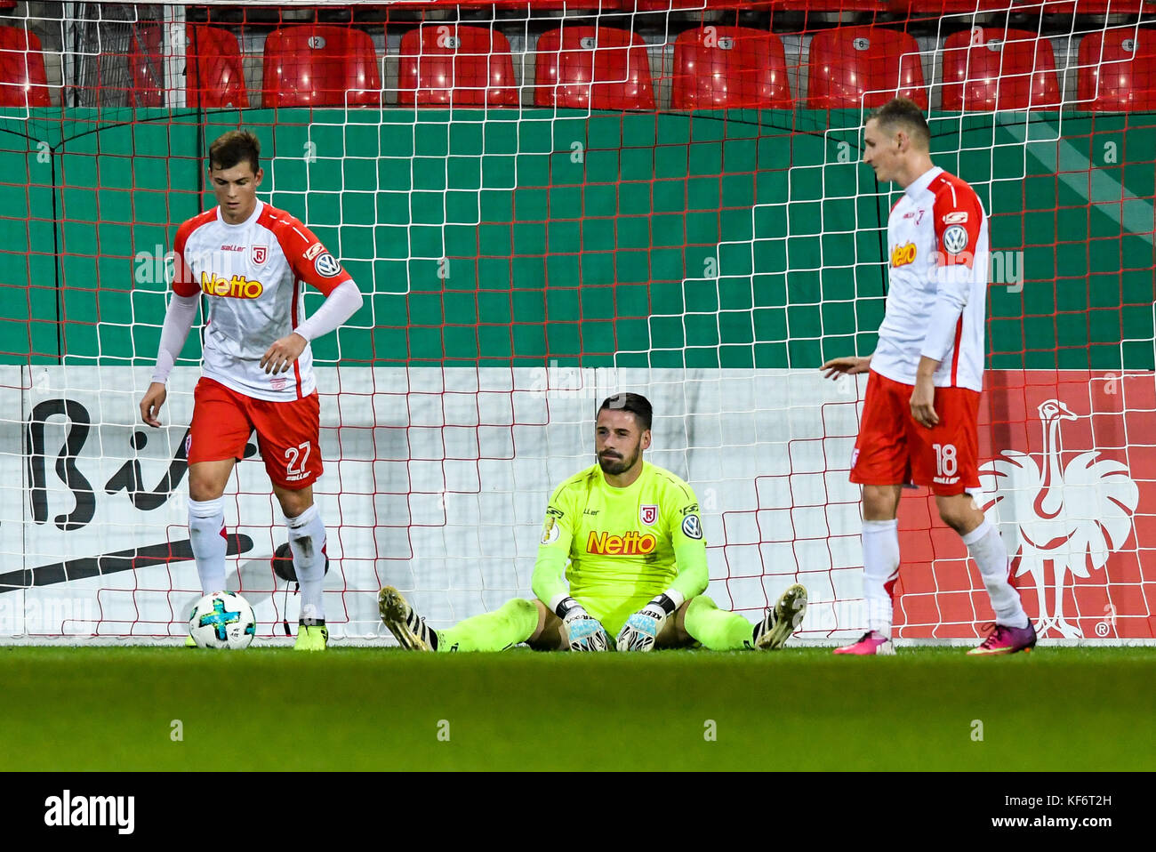 Regensburg's goalkeeper Philipp Pentke picks up a seat that was thrown onto  the turf during the German Bundesliga 2nd division relegation soccer match  between TSV 1860 Munich and Jahn Regensburg in the