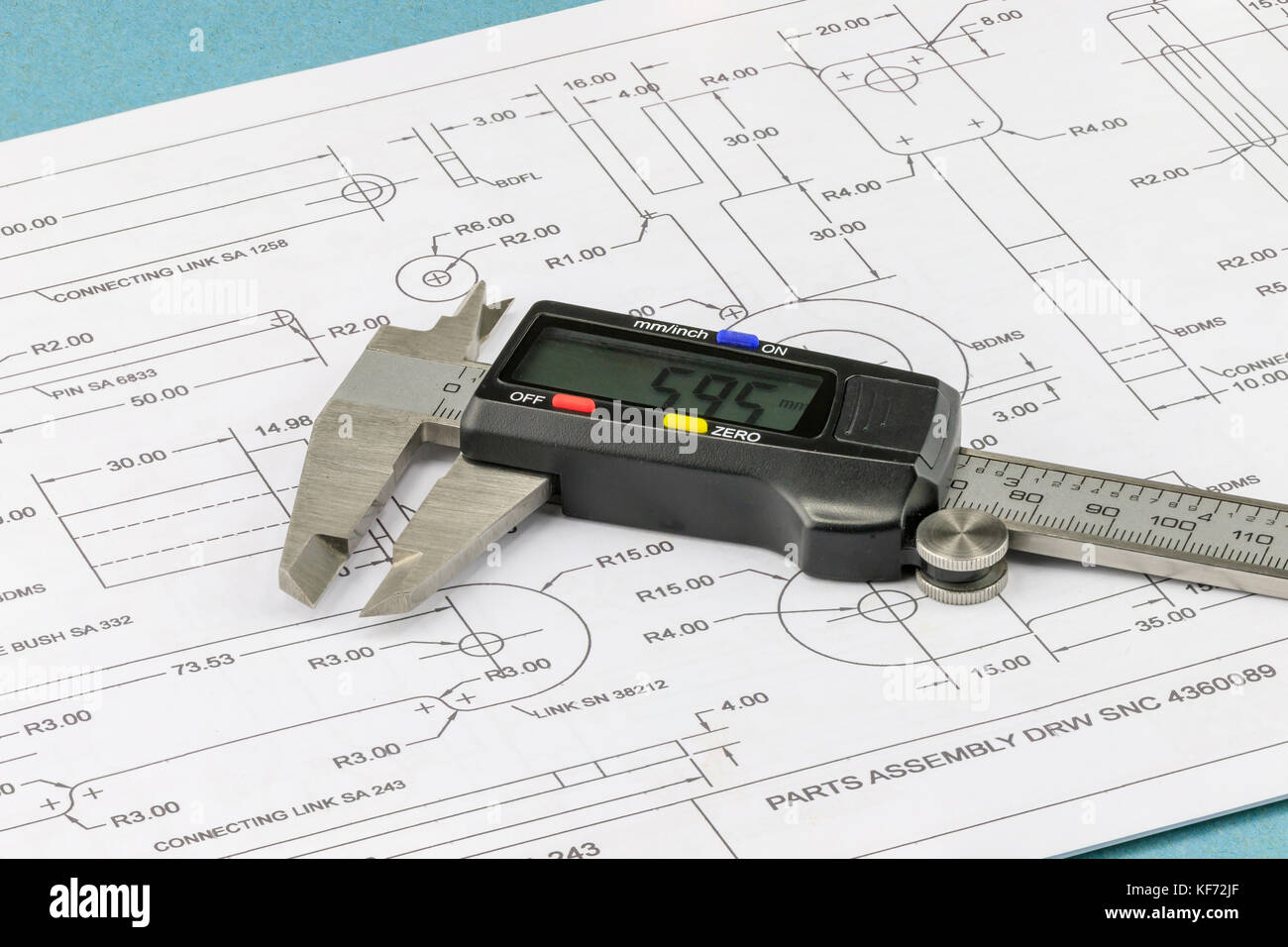 Close up on an engineering vernier calliper placed on an engineering drawing background Stock Photo