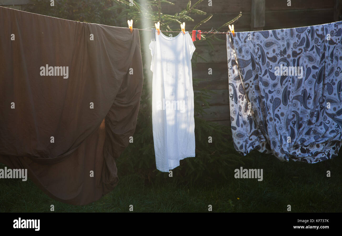 cotton bed sheets and linen, hang out on a laundry line outside in the
