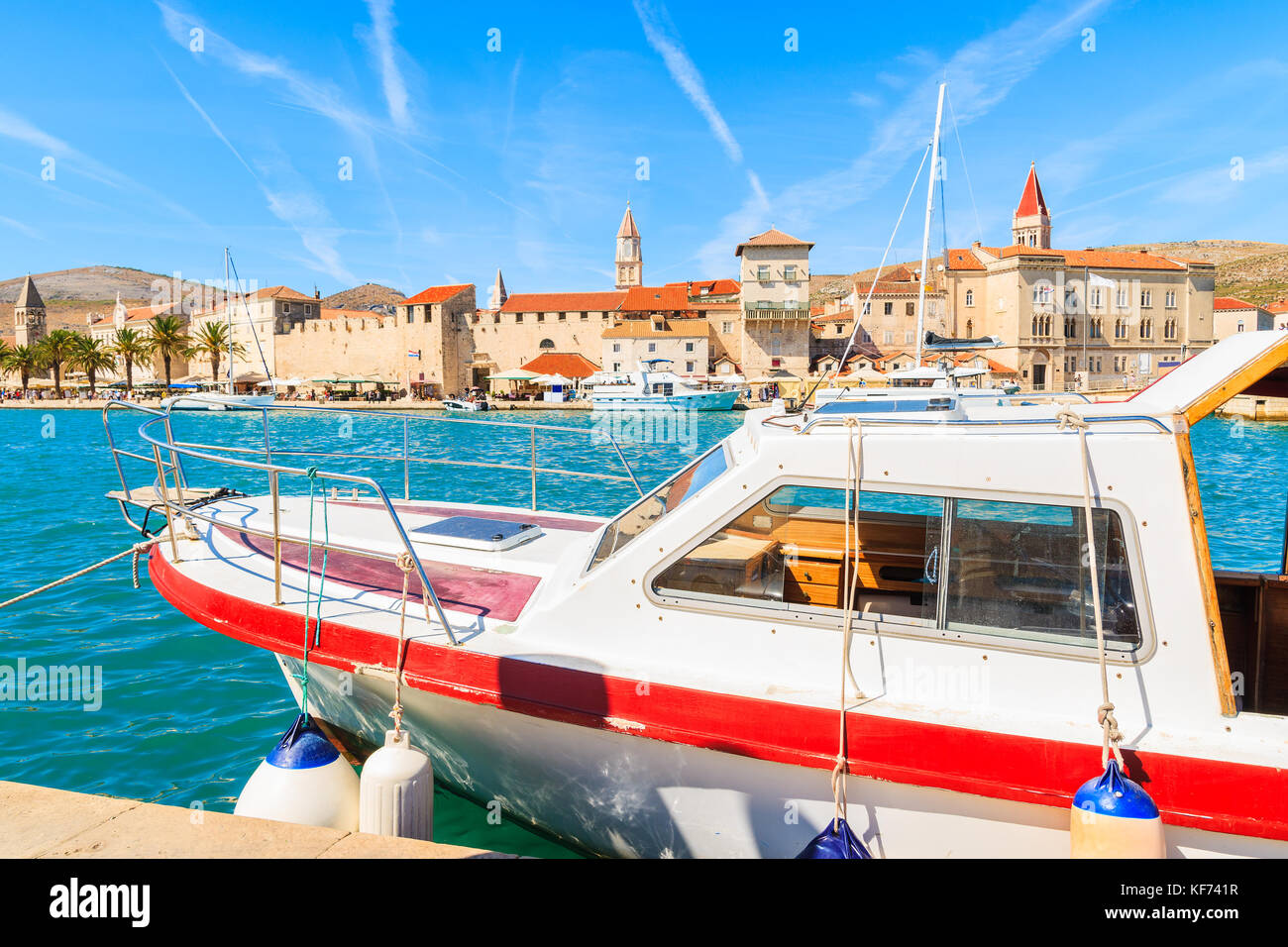 Boat anchoring in Trogir town with beautiful historic buildings in background, Croatia Stock Photo