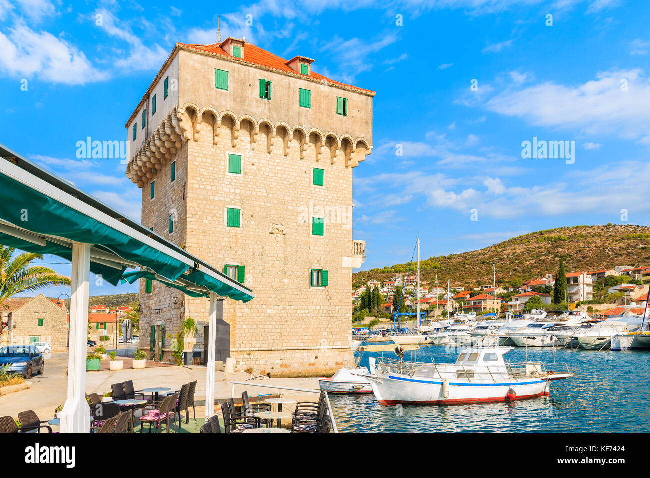 Old tower and fishing boat in marina Agana near Trogir town, Croatia Stock Photo