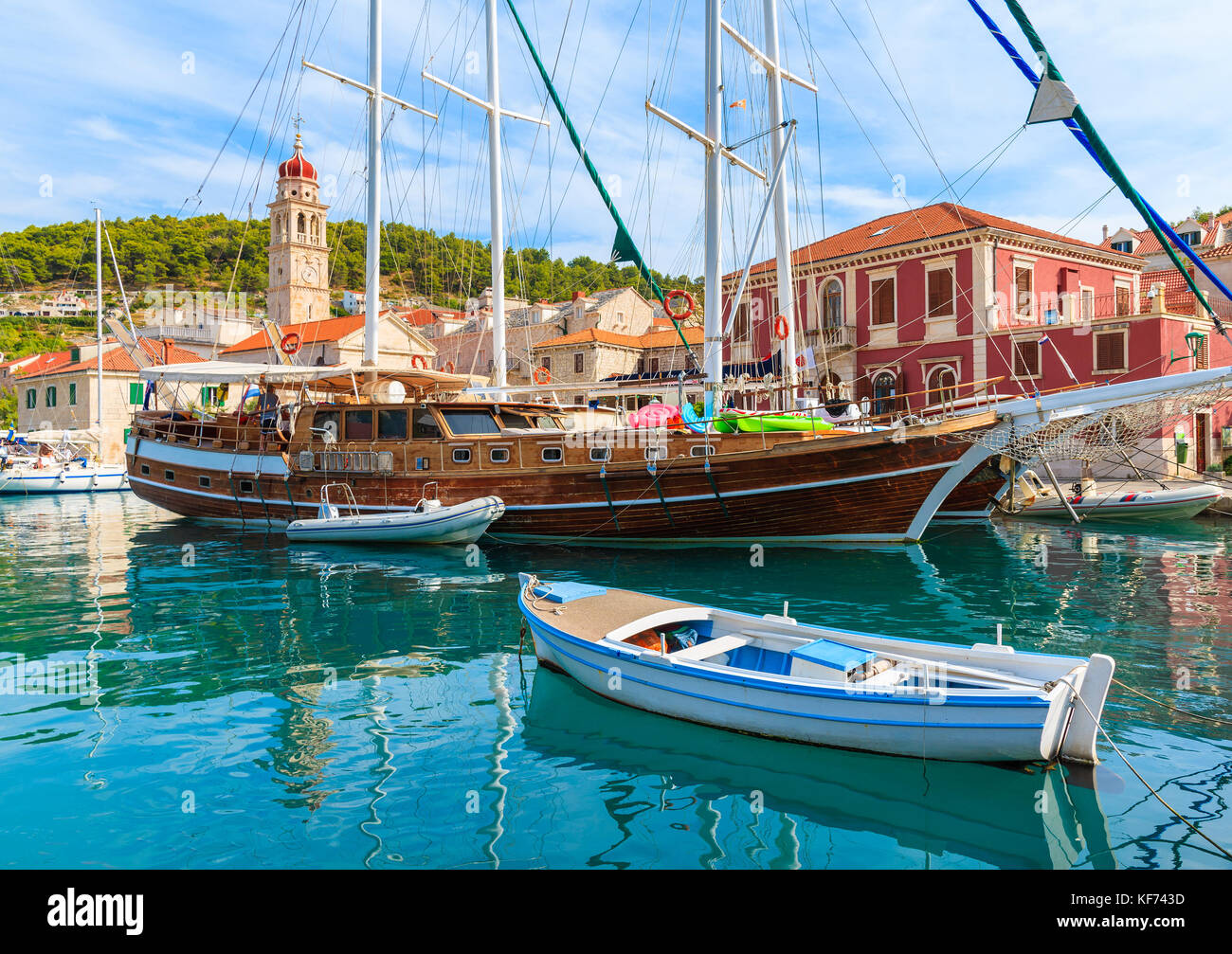 Fishing boat and wooden yacht in Pucisca beautiful port, Brac island, Croatia Stock Photo