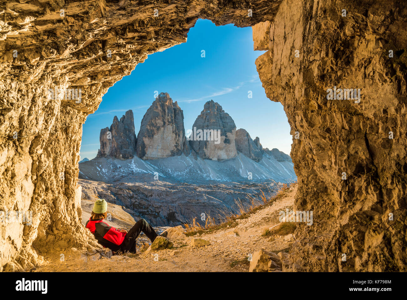 Male hiker watching the Tre Cime di Lavaredo peaks or Drei Zinnen, Dobbiaco - Toblach, Trentino - Alto Adige or South Tyrol, Italy Stock Photo