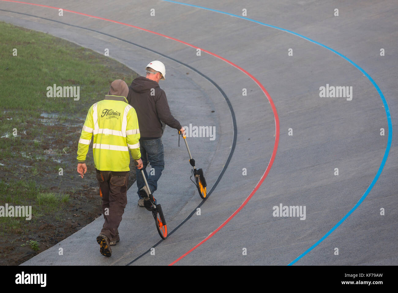 two-men-using-trundle-wheels-measure-the-distance-around-the-velodrome