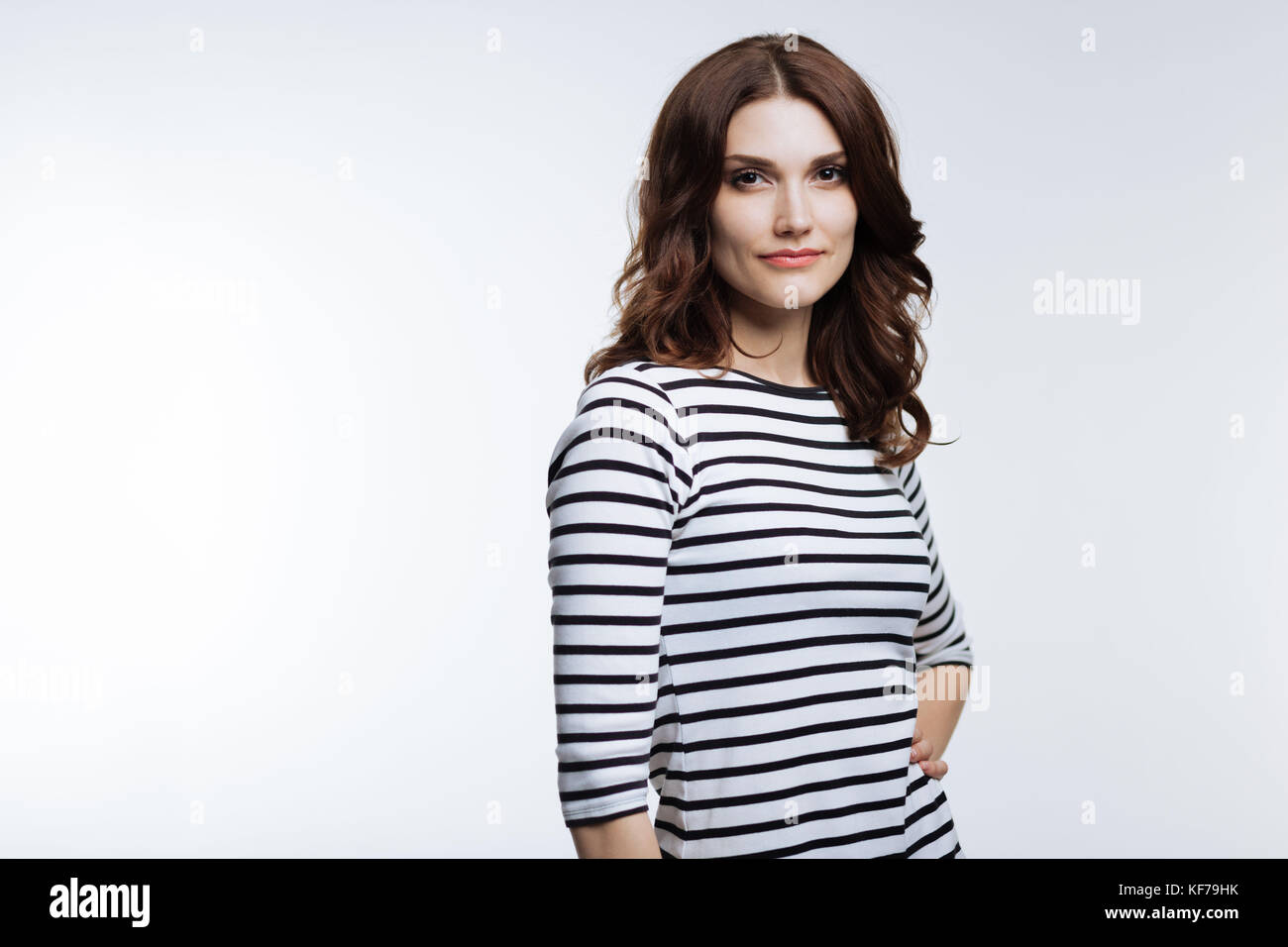 Beautiful woman in striped pullover posing Stock Photo Alamy