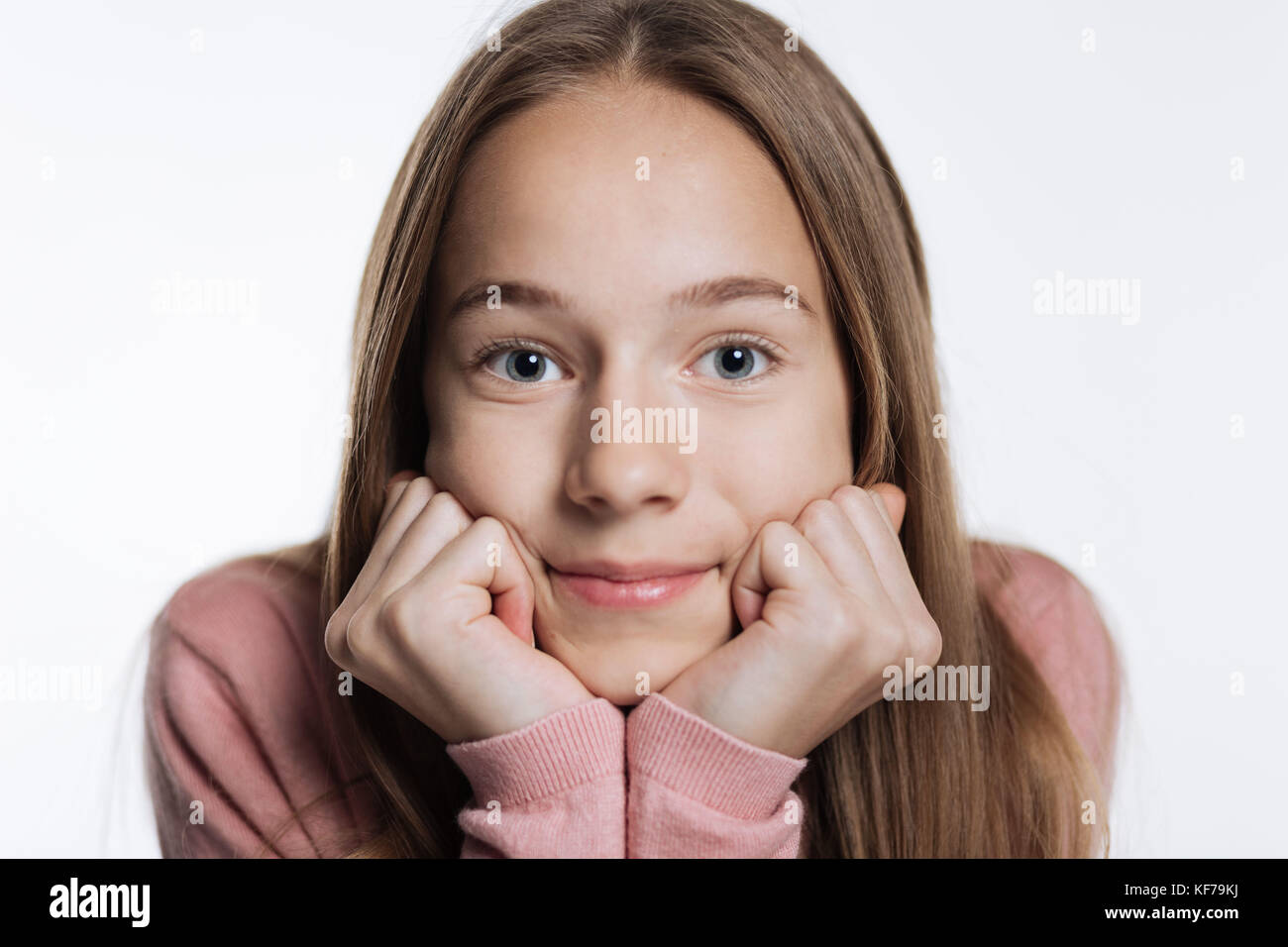 Fair-haired teenage girl resting her chin on hands Stock Photo - Alamy