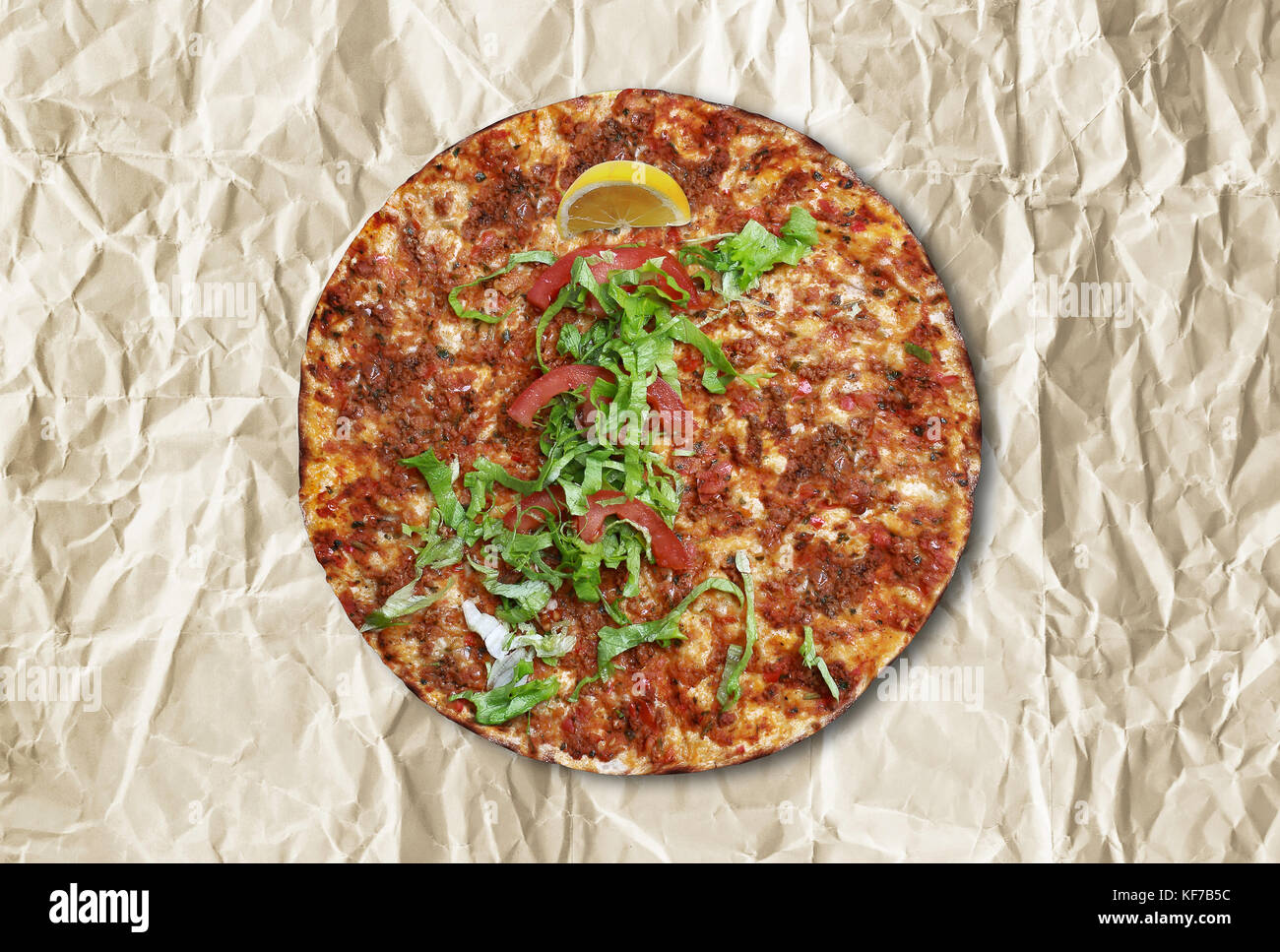 'Turkish lahmacun' on a wrinkled paper. Stock Photo