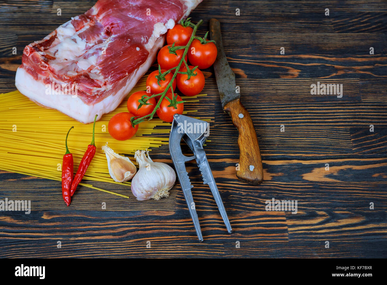 Raw juicy meat steaks ready for roasting on a black chalk board background. Rib eye steak on the