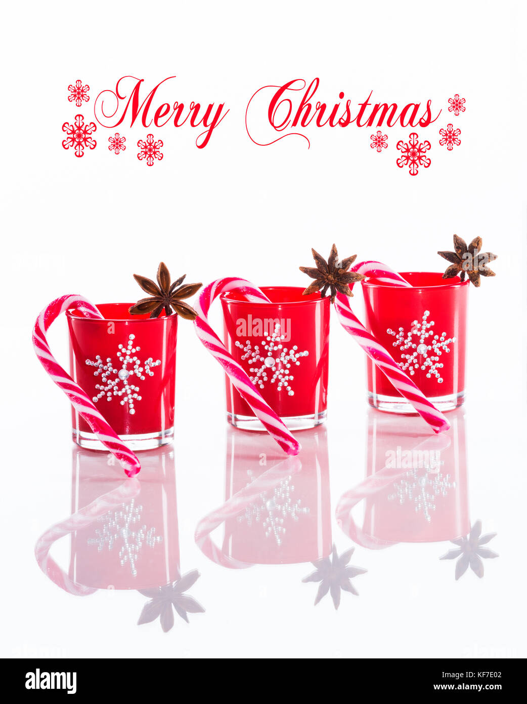 Red candles, candle holders with crystal snowflakes and sugar canes