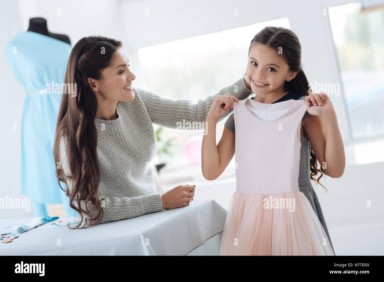 Positive young girl being happy about the dress Stock Photo