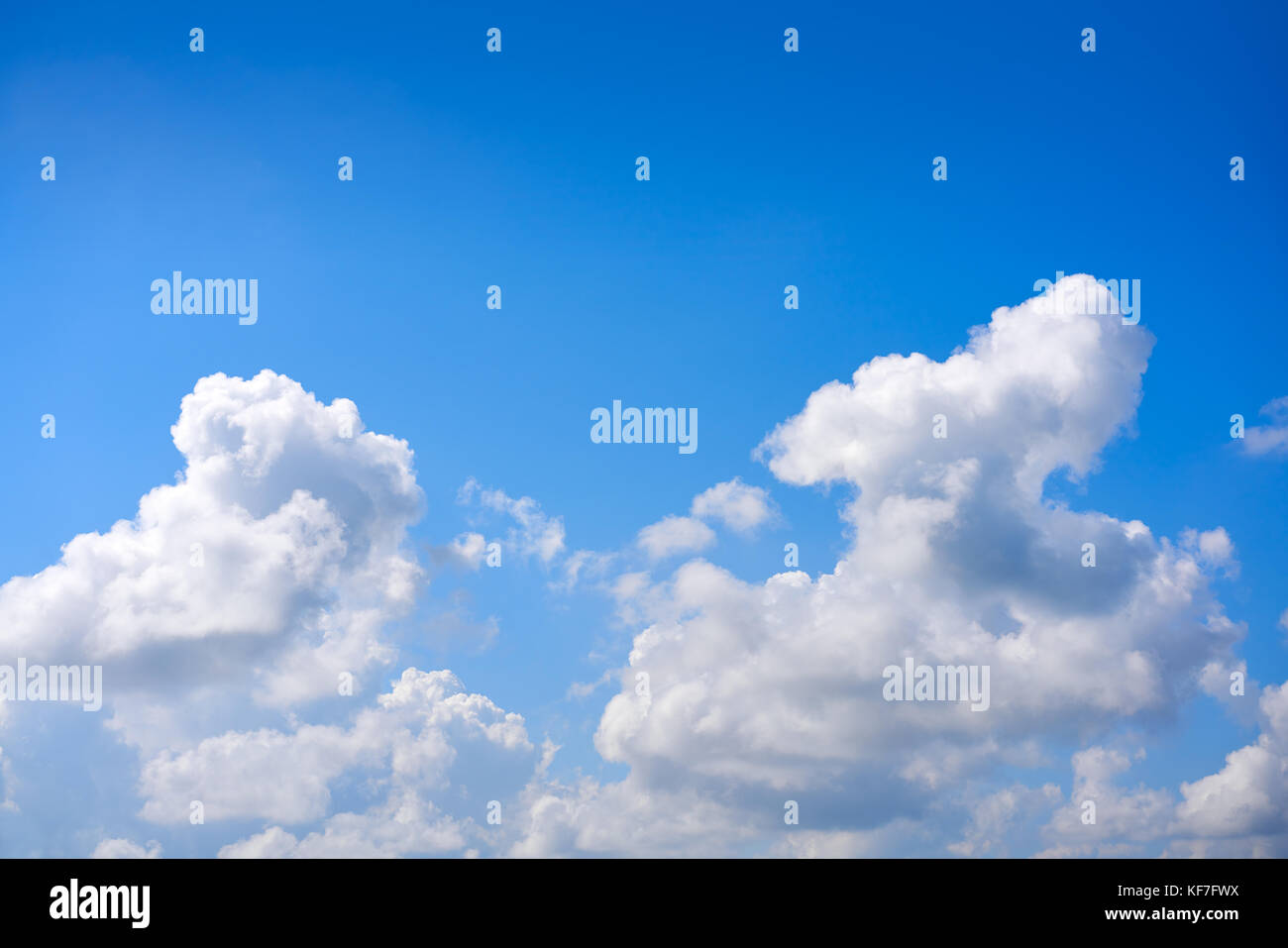 Blue sky white cumulus clouds background Stock Photo - Alamy