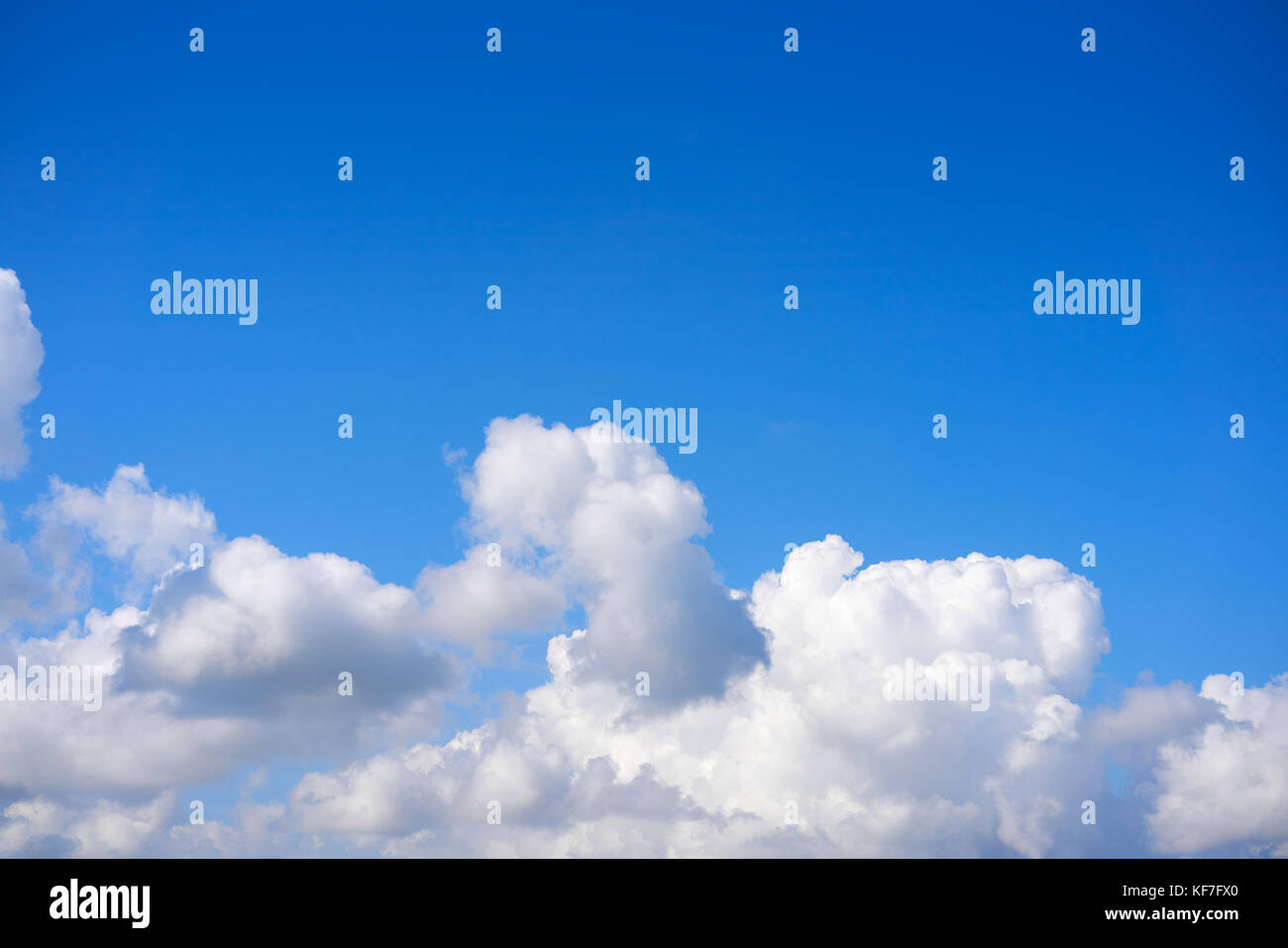 Blue sky white cumulus clouds background Stock Photo - Alamy