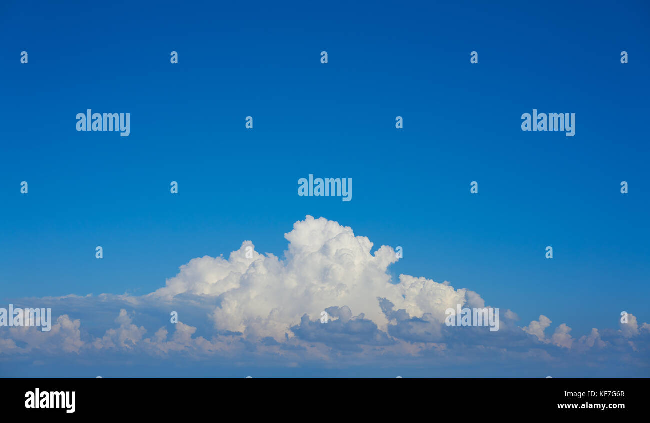 Blue sky white cumulus clouds background Stock Photo - Alamy