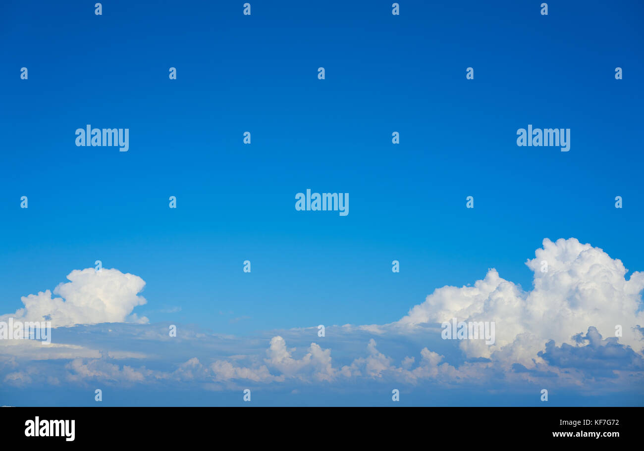 Blue sky white cumulus clouds background Stock Photo - Alamy