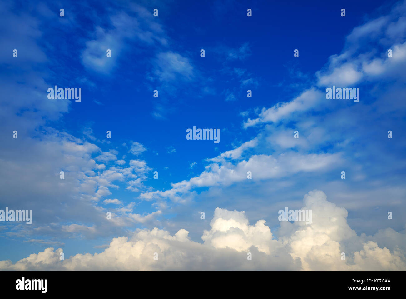 Blue sky white cumulus clouds background Stock Photo - Alamy