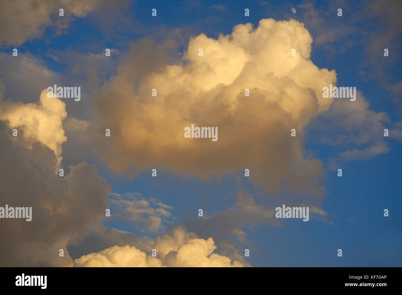 Blue sunset sky golden cumulus clouds background Stock Photo - Alamy