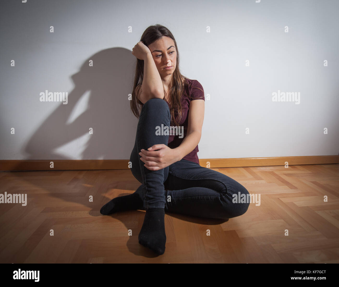 Depressed young woman sitting on floor in empty room,sad depression ...
