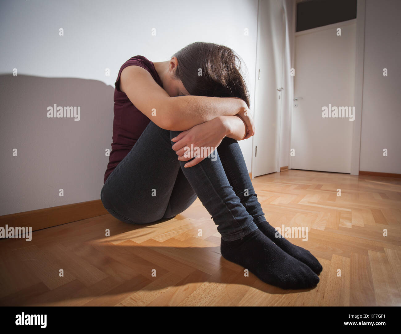 Depressed young woman sitting on floor in empty room,sad depression ...