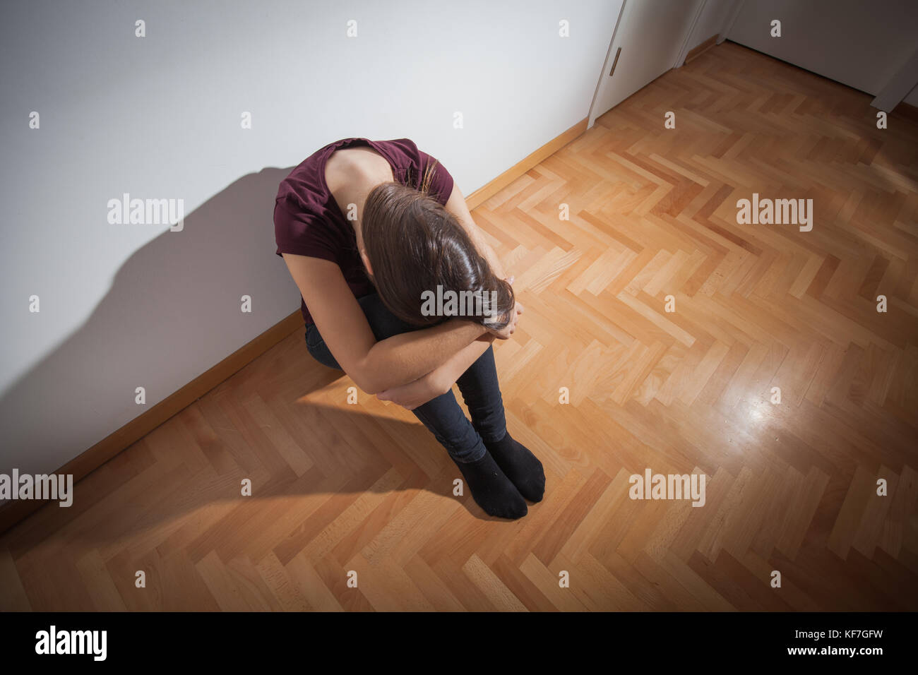 Depressed young woman sitting on floor in empty room,sad depression ...