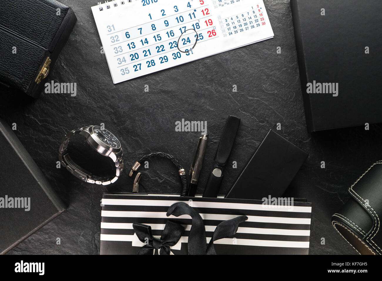 Package with a black bow and with gifts and a clock, various boxes, calendar horizontal Stock Photo