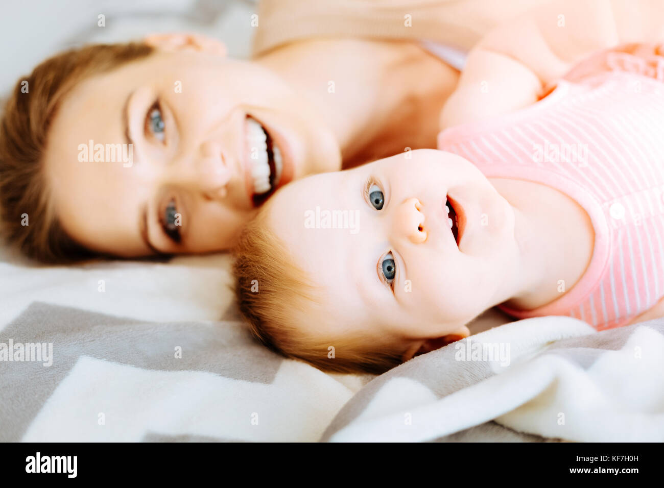 Excited little child being near a smiling mother Stock Photo