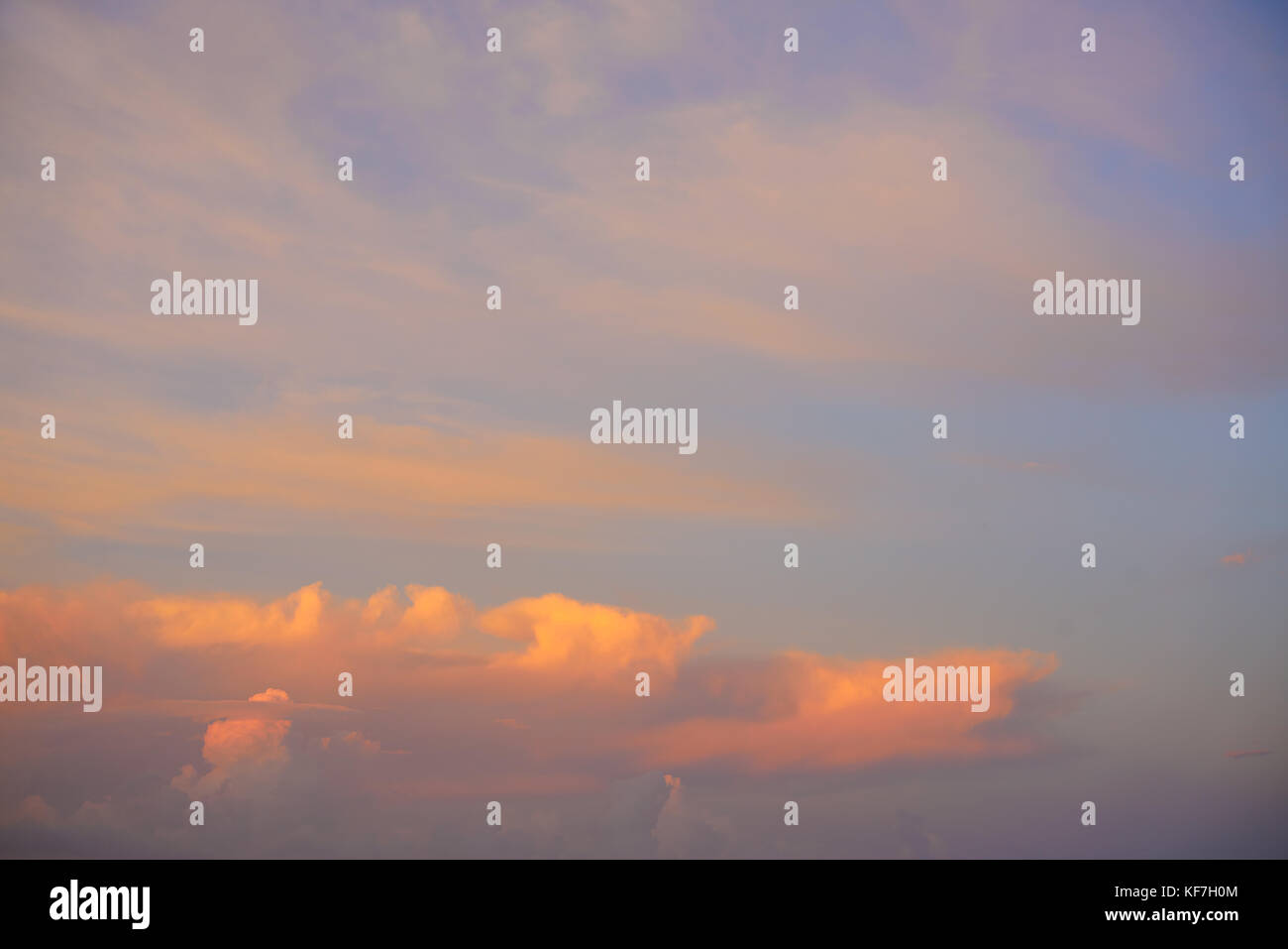 Sunset sky with orange golden clouds on blue background Stock Photo - Alamy