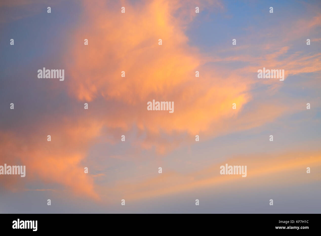 Sunset sky with orange golden clouds on blue background Stock Photo - Alamy