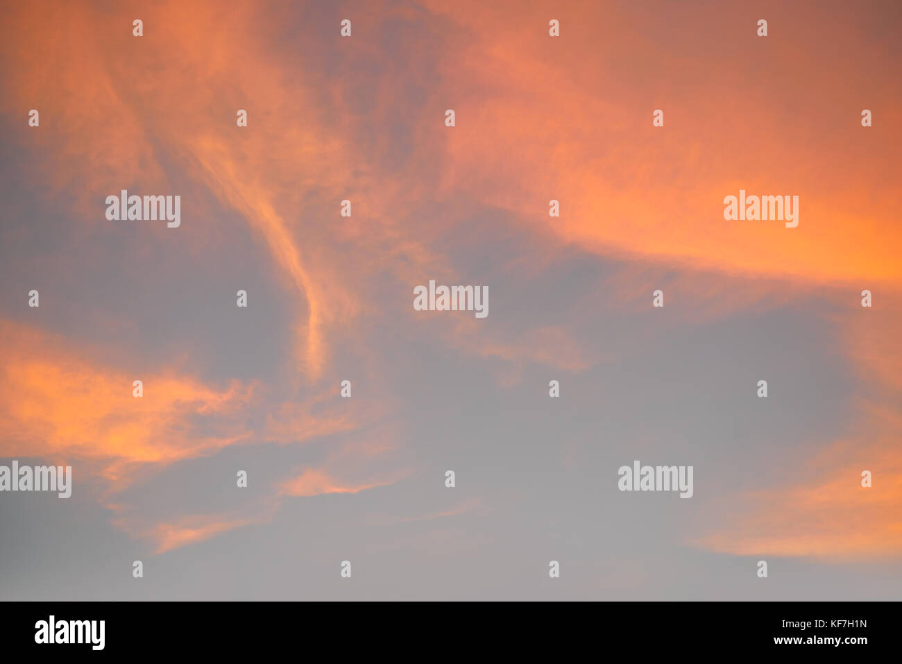 Sunset sky with orange golden clouds on blue background Stock Photo - Alamy