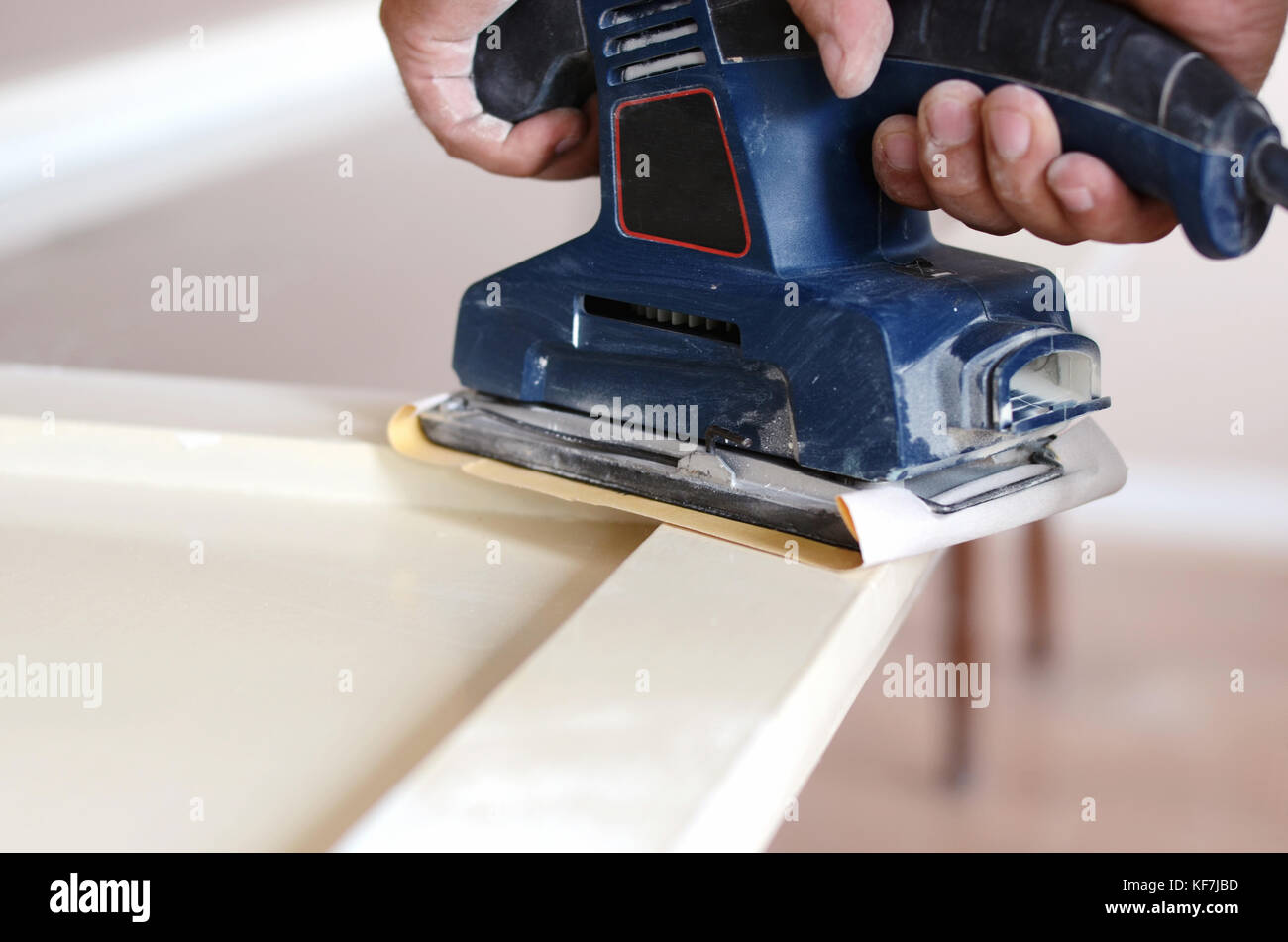 Sanding and preparing old doors with cracked paint for a new lick of